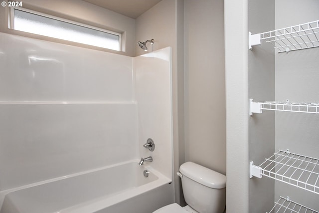 bathroom featuring shower / bathtub combination and toilet