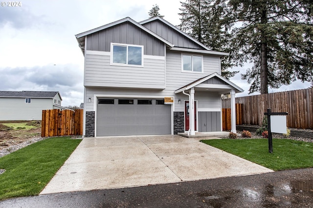 view of front of property featuring a garage, fence, board and batten siding, and concrete driveway