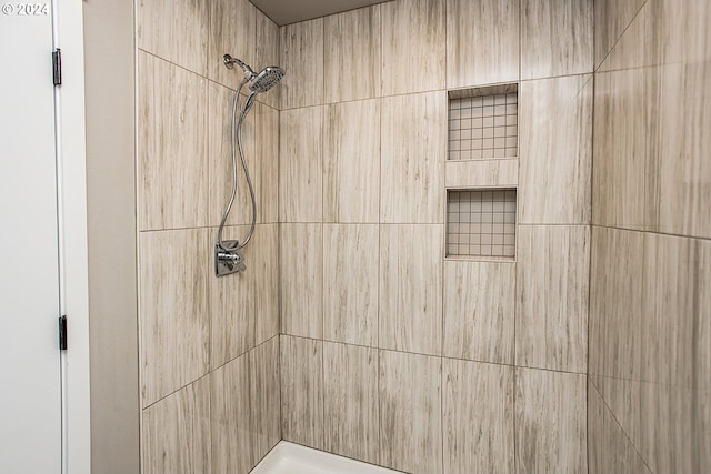 bathroom with tiled shower