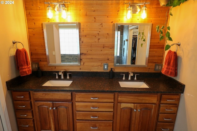 bathroom featuring vanity and wooden walls