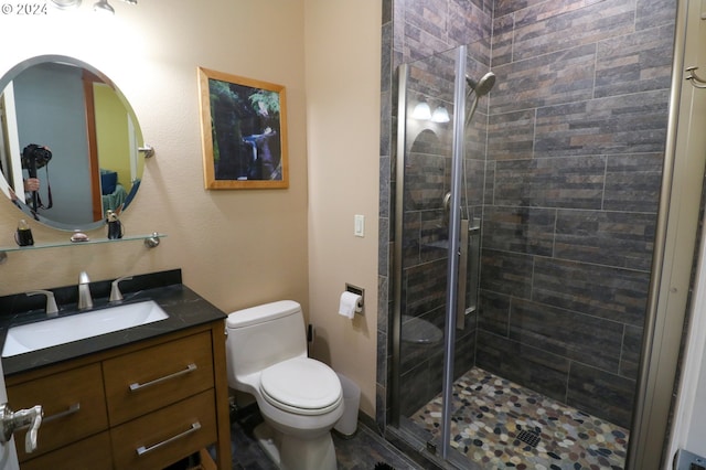 bathroom featuring walk in shower, vanity, and toilet