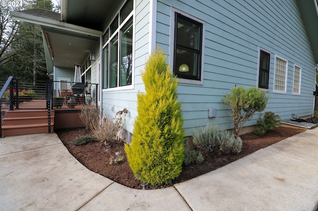 view of side of property with a porch