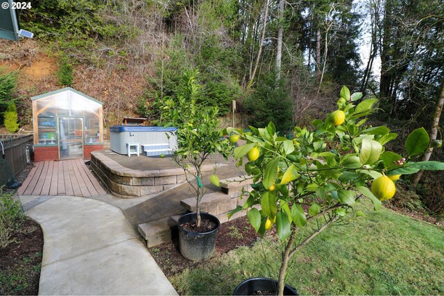 wooden terrace with a water view and a yard