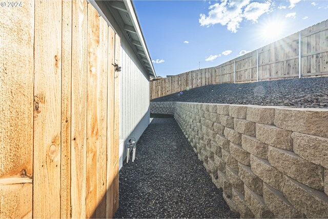 view of side of home featuring a fenced backyard