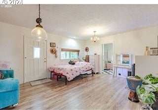 bedroom with wood-type flooring and a chandelier