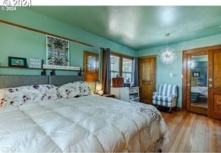 bedroom featuring hardwood / wood-style floors and an inviting chandelier