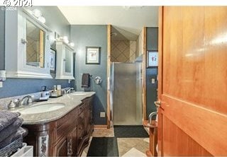 bathroom featuring sink and an enclosed shower