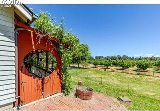 exterior space featuring a rural view and a deck