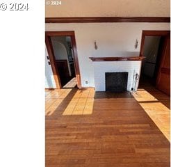 unfurnished living room with hardwood / wood-style flooring