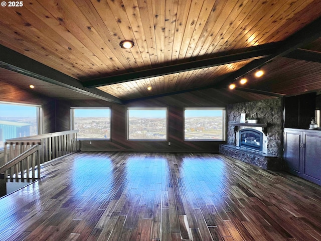 unfurnished living room featuring dark hardwood / wood-style flooring, wood ceiling, vaulted ceiling with beams, and a stone fireplace