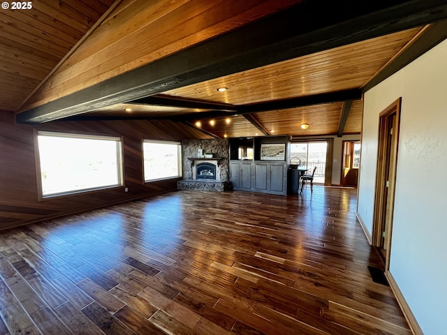 unfurnished living room with dark wood-type flooring, vaulted ceiling with beams, wood ceiling, and a fireplace