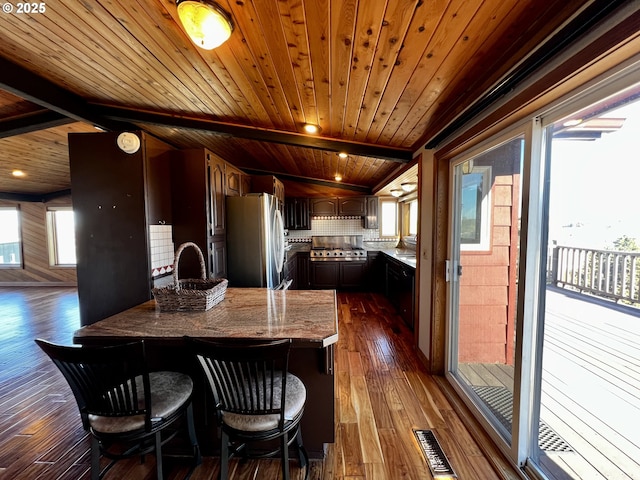 dining room with dark wood-type flooring and wooden ceiling