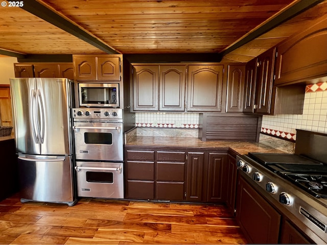 kitchen with backsplash, appliances with stainless steel finishes, dark hardwood / wood-style floors, and wood ceiling