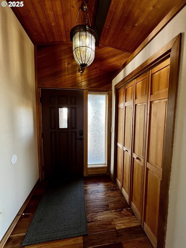 foyer with dark wood-style floors, an inviting chandelier, wooden ceiling, and baseboards