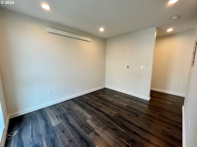 unfurnished room featuring dark hardwood / wood-style flooring