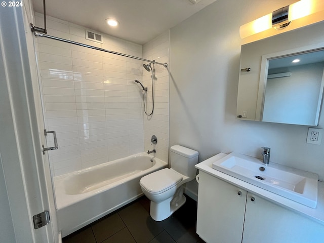 full bathroom featuring tiled shower / bath, vanity, toilet, and tile patterned floors