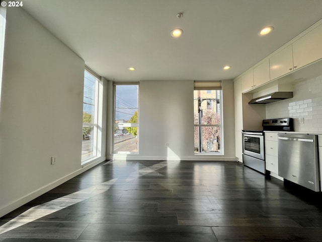 kitchen featuring backsplash, appliances with stainless steel finishes, white cabinetry, and plenty of natural light