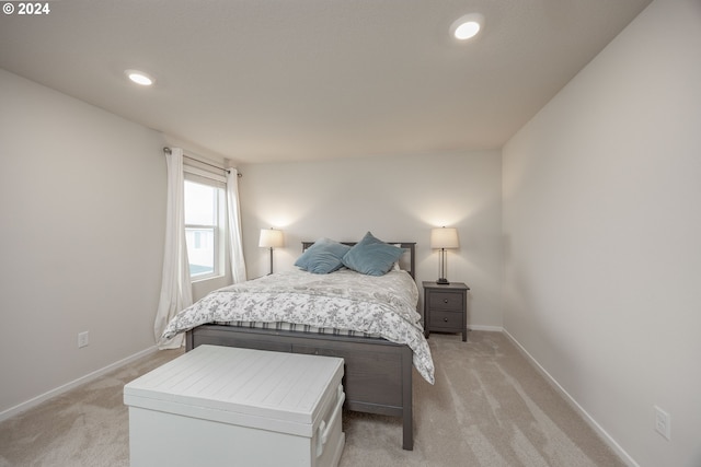 bedroom featuring light colored carpet