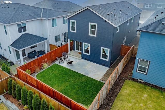 rear view of property featuring a patio area and a lawn