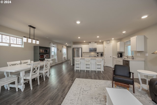 dining room with dark hardwood / wood-style flooring and sink