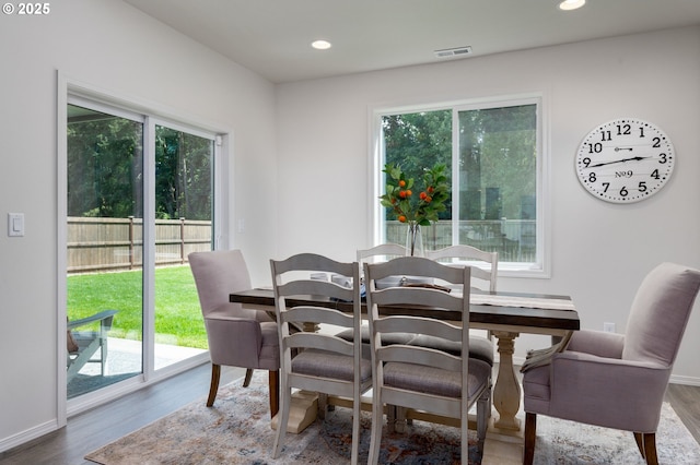 dining space with hardwood / wood-style flooring and a healthy amount of sunlight