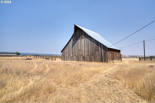 view of outbuilding with a rural view