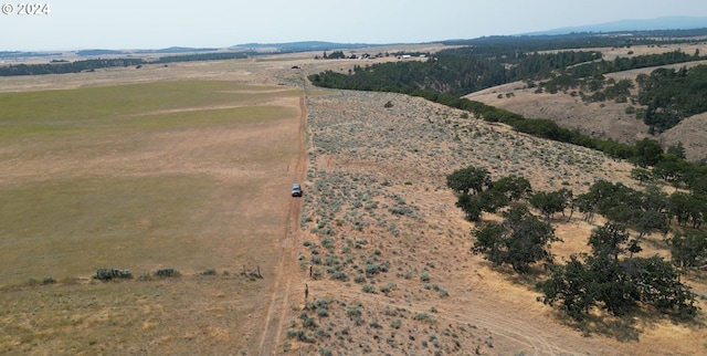 drone / aerial view featuring a rural view and a mountain view