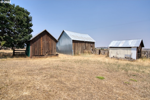 view of yard with an outbuilding and a rural view