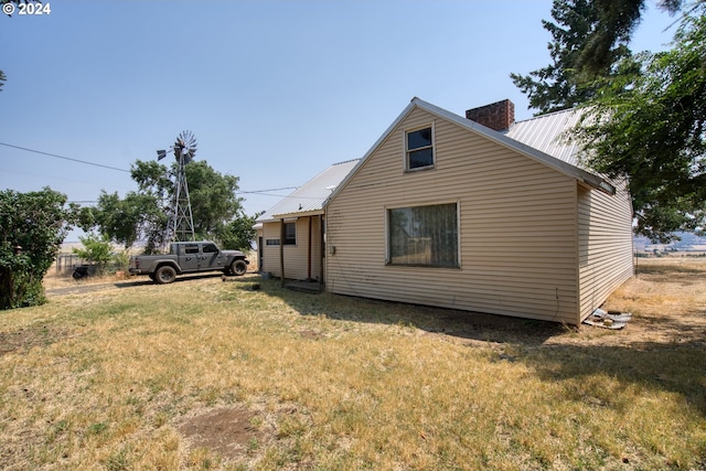 view of property exterior featuring a lawn