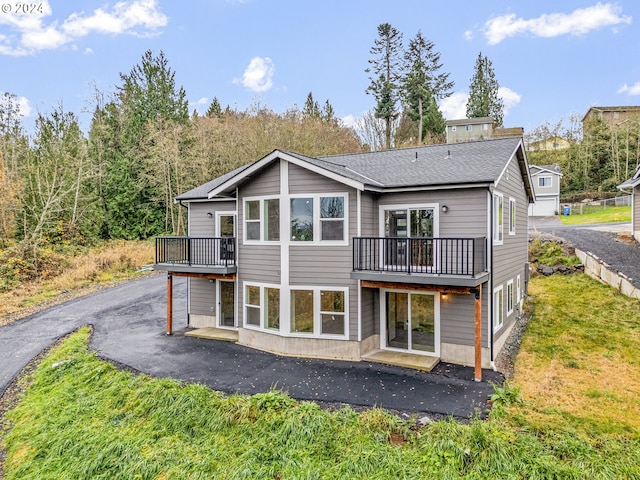 back of property featuring a yard and a wooden deck