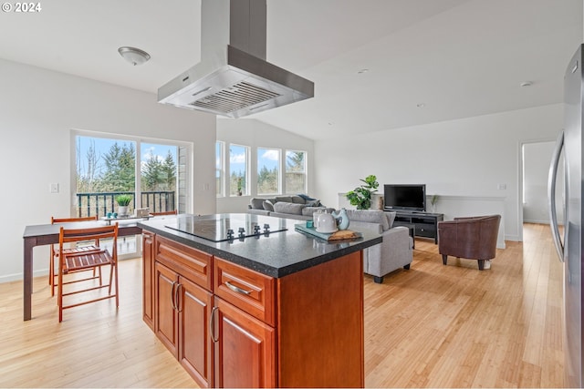 kitchen with a center island, stainless steel fridge, light hardwood / wood-style floors, island range hood, and black electric stovetop