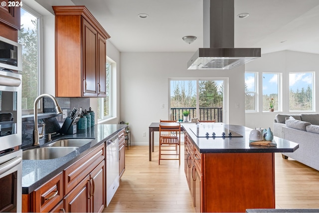 kitchen featuring a center island, island range hood, and a wealth of natural light