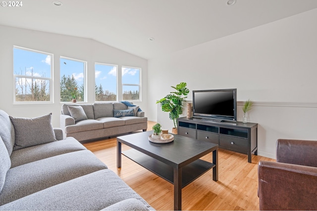 living room featuring hardwood / wood-style flooring and vaulted ceiling