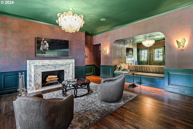 living room featuring a premium fireplace, crown molding, and dark wood-type flooring