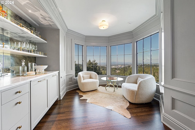 living area with dark hardwood / wood-style flooring and ornamental molding