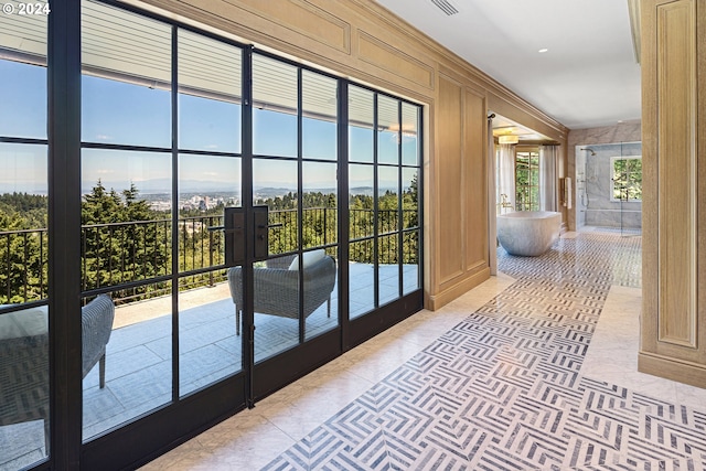 doorway to outside with wood walls, french doors, light tile patterned floors, and a healthy amount of sunlight