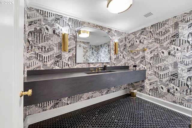 bathroom with ornamental molding and sink