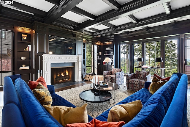 living room featuring hardwood / wood-style flooring, a healthy amount of sunlight, beam ceiling, and coffered ceiling