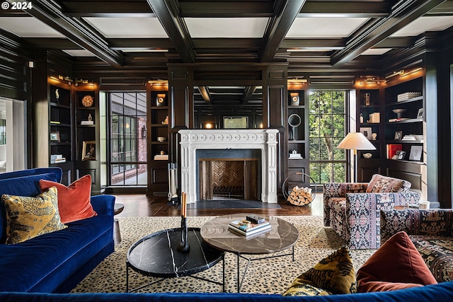 living room with built in features, beamed ceiling, and coffered ceiling