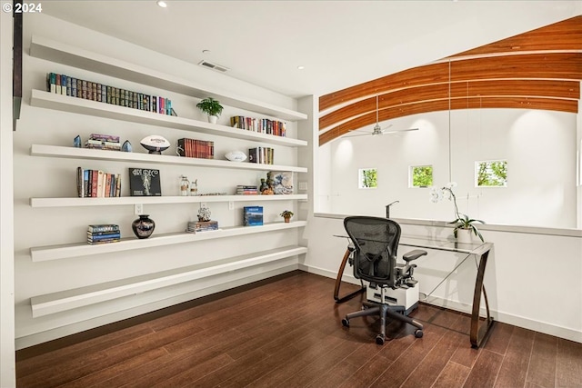 home office featuring ceiling fan, dark wood-type flooring, and lofted ceiling