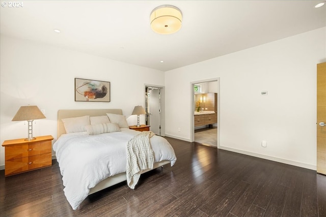 bedroom with dark wood-type flooring and ensuite bath