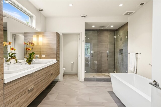 full bathroom with shower with separate bathtub, toilet, tile patterned flooring, and vanity