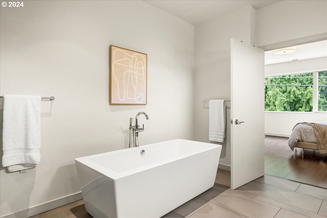 bathroom with a bathing tub and wood-type flooring