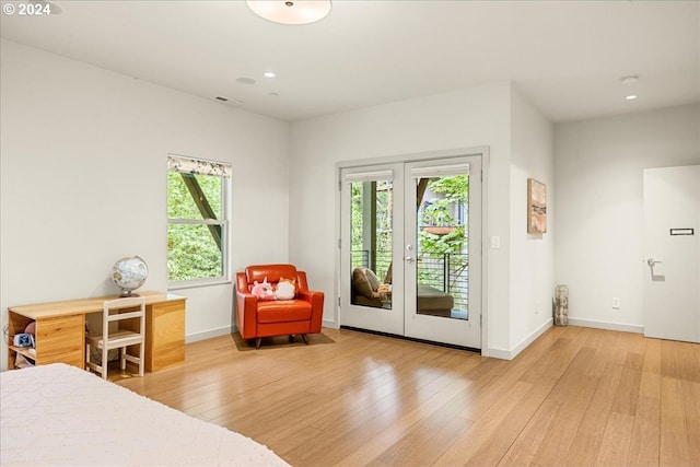 bedroom with light wood-type flooring, french doors, and access to exterior