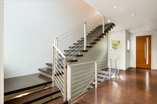 stairs with hardwood / wood-style floors