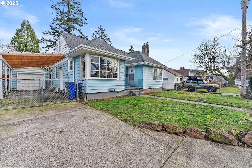 view of front of property featuring concrete driveway, a chimney, a gate, fence, and a front yard