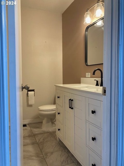 bathroom with vanity and toilet