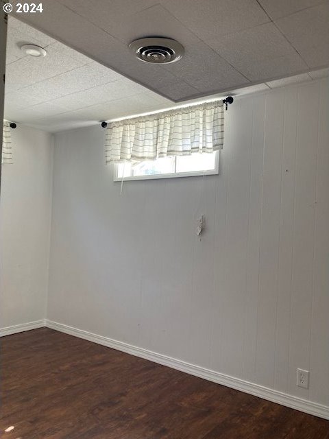 spare room featuring dark wood-type flooring