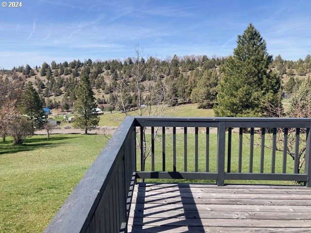 wooden terrace with a lawn