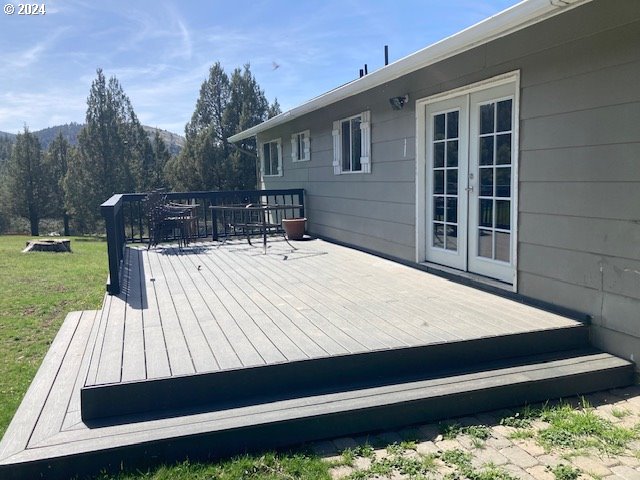 deck featuring a yard and french doors